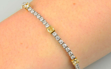 An 18ct gold 'yellow' diamond and diamond line bracelet.