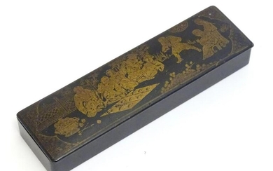 An early 20thC lacquered papier mache pen box decorated