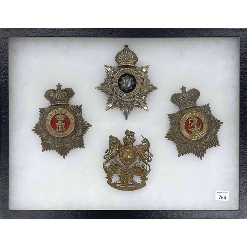 Group of four good large military helmet badges, to include ...