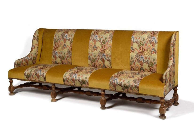 Large walnut winged sofa, the base turned with balusters and spacers, covered with velvet and tapestry strips to the point. 19th century. H : 102 cm, W : 242 cm Provenance : Château de La Roche-Guyon