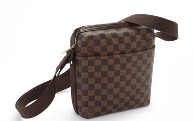 SOLD. Louis Vuitton: A messenger bag of brown Damier Ebene coated canvas with one large...