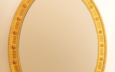 Miroir ovale en bois doré à décor de cannelures. Style Louis XVI. H_123 cm L_85...