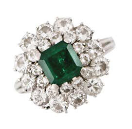 Platinum ring with emerald surrounded by a double...