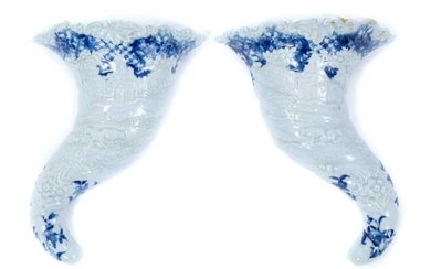 Rare pair of Worcester cornucopia wall pockets, circa 1755, moulded with landscape scenes, with floral and other patterns in underglaze blue, painter's marks to backs, 21cm long