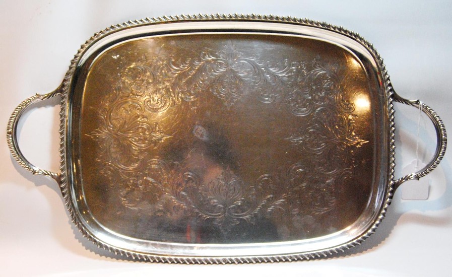Silver tray of bowed rectangular shape with engraved scrolls...