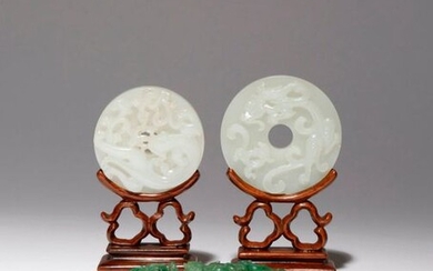 TWO CHINESE WHITE JADE BI AND A SPINACH-GREEN JADE BELTHOOK...