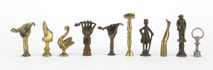 Ten antique pipe tampers including swan, figural, boot and h...