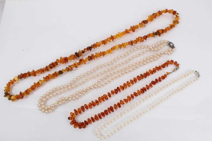 Two amber bead necklaces, cultured pearl necklace with silver clasp and one other simulated pearl necklace (4)