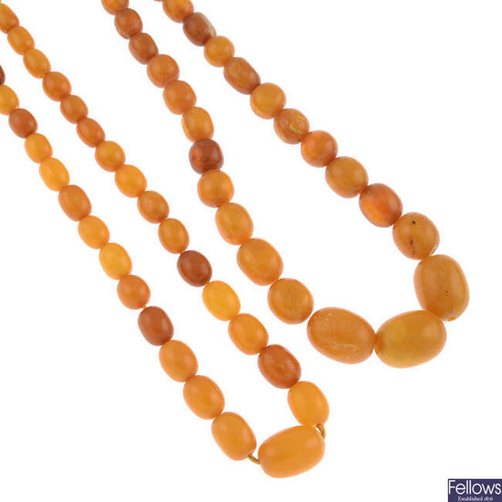 Two amber bead necklaces, two coral bead necklaces, a Bakelite scarf ring and a selection of Bakelite beads.