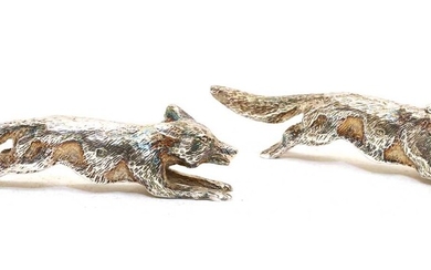 Two silver running fox ornaments