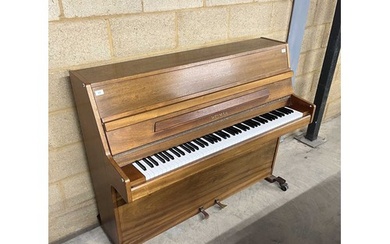 Welmar (c1983) An upright piano in a mahogany case.