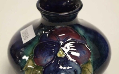 William Moorcroft 'Petunia' posy vase decorated on dark blue...