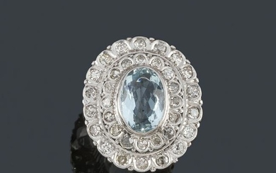 Ring with oval aquamarine and double border of diamonds