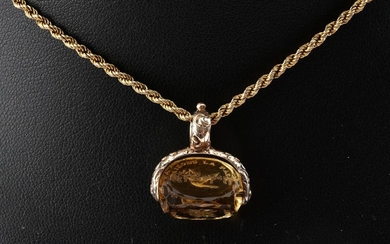 A CARVED CITRINE SEAL, NECKLACE, GOLD LINED