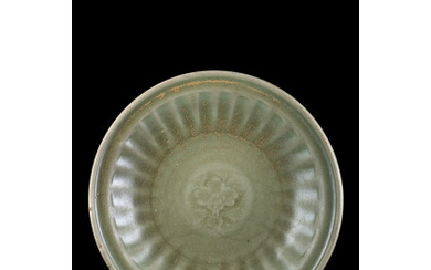 A celadon glazed dish with incised floral decoration China, Ming dynasty (1368-1644) (d. 30 cm.)