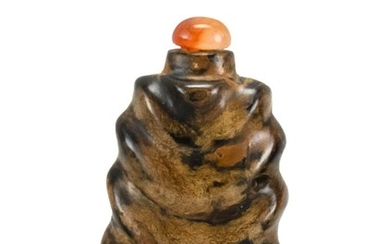 CHINESE SEA AMBER SNUFF BOTTLE In irregular form. Height 2". Carnelian stopper.