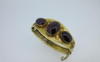 A Victorian hinged bangle set with garnet carbuncles