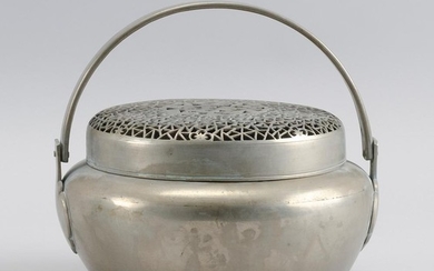 CHINESE BAITONG FOOT WARMER In ovoid form, with swing handle. Pierced cover in a prunus and cracked ice design. Diameter 7.5".