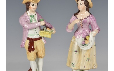 A 19th century pair of Staffordshire figures, of a young man...