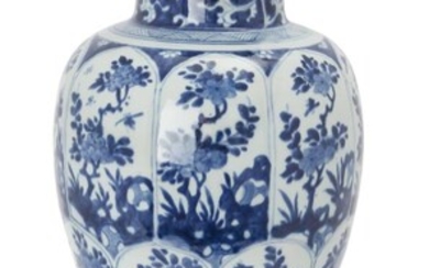 A Chinese blue and white baluster vase, Kangxi period, of tapered form standing on splayed foot rising to rounded shoulders and trumpet neck, painted to the body with panels of peonies on branches emerging from rocks, the neck decorated with...