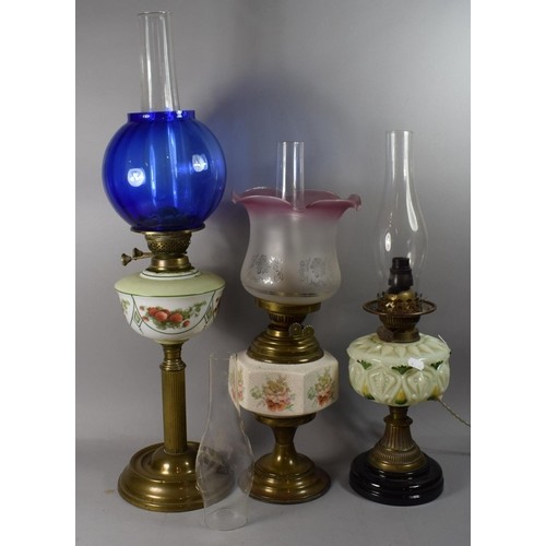 A Collection of Three Oil Lamps, One Converted to Electricit...
