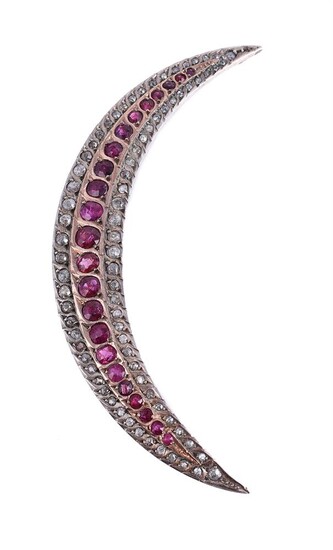 A DIAMOND AND RUBY CRESCENT BROOCH