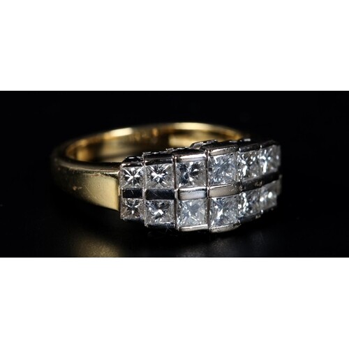 A DIAMOND RING in 18ct yellow and white gold, the graduated ...