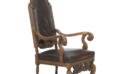A Danish Baroque style oakwood armchair with leather cover. Early 20th century.