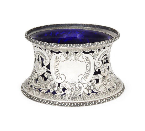 A George V silver potato dish ring with blue glass liner, London, 1926, Ellis & Co., the waisted silver mount pierced and decorated with scenes of figures picking flowers alongside bird and scroll motifs, the cartouche vacant, 11.1cm high, base...