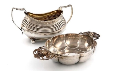 A German silver-two handled brandy bowl, by Neresheimer of Hanau, with import marks for London 1910, importer~s mark of Berthold Muller, lobed oval form, the pierced side handles with cherub masks, length 24cm, plus a George III silver two-handled...