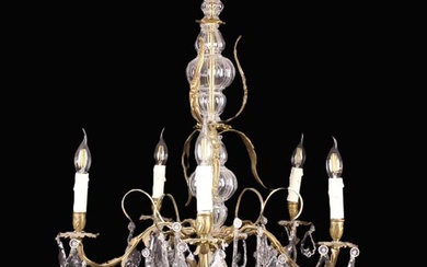 A Gilt Metal & Glass Five Light Chandelier. The S-scroll arms emanating from a cast gilt foliate who