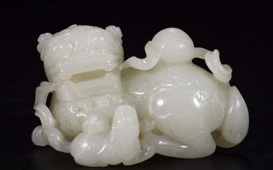 A HETIAN JADE LION PLAYING BALL ORNAMENT