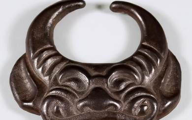 A Japanese Russet Iron Maedate, 19th Century, formed from...