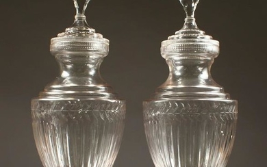 A LARGE PAIR OF CUT GLASS PEDESTAL URNS AND COVERS.