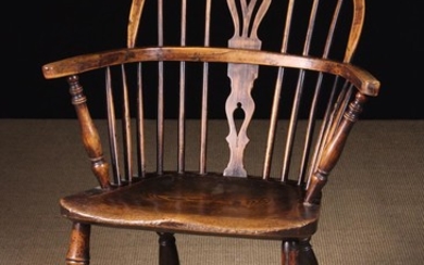 A Low Back Windsor Armchair having a yew-wood back hoop and bow. The pierced upper & lower centre sp