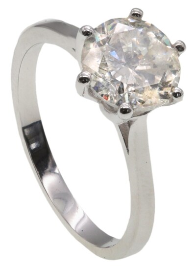 A Magnificent Diamond Ring The deep brilliant cut diamond claw set to a plain platinum band. To...