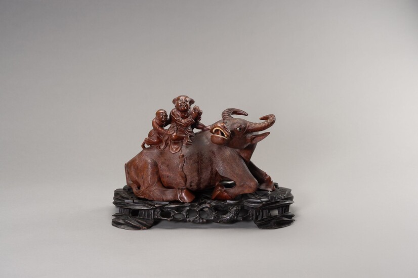 A VERY LARGE WOOD SCULPTURE OF AN IMMORTAL AND SERVANT RIDING A WATER BUFFALO