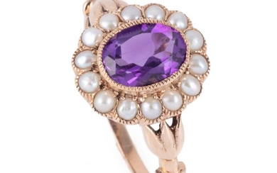A VICTORIAN STYLE AMETHYST AND PEARL CLUSTER RING; centring an oval cut amethyst to surround of seed pearls in 9ct rose gold, size N...