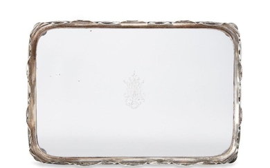 A Victorian glass tray with shaped silver rim, London, c.1889, Hukin & Heath, of rectangular form, the monogrammed glass to crimped silver rim, the tray raised on four ball feet, 31.2 x 21cm