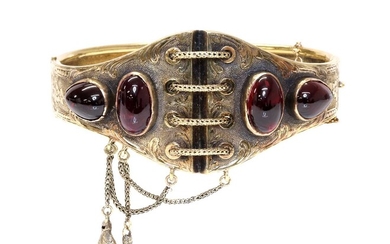 A Victorian gold garnet set hinged bangle, c.1860