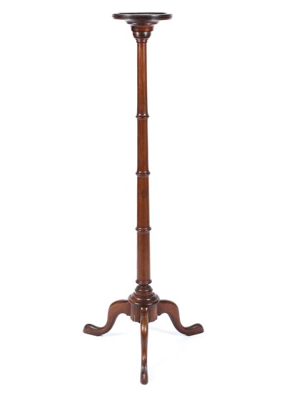 A Victorian mahogany torchere, raised on a turned fluted column
