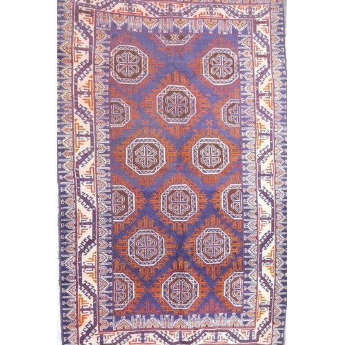 A blue ground Middle Eastern wool rug with a Bokhara style d...