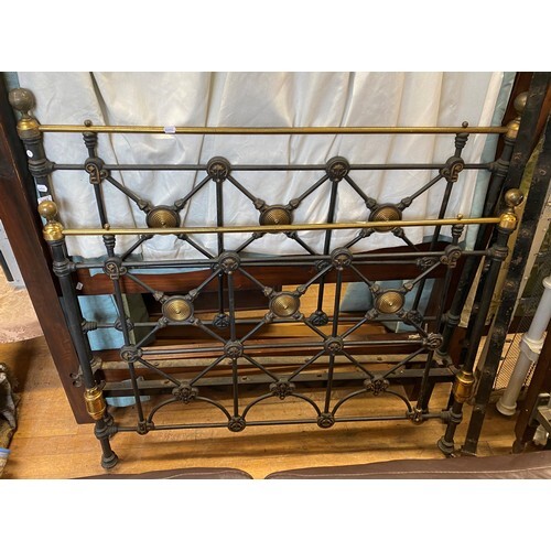 A cast iron and brass double bedframe, 136 cm wide
