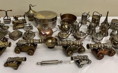 A collection of miniature metal items, consisting of brass...