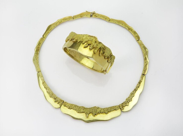 A demi-parure, comprising a necklace and hinged bangle, the necklace composed of a series of partially textured panels, the bangle of matching design, necklace with Italian assay marks, inner circumference 38cm, bangle 17cm, gross weight...