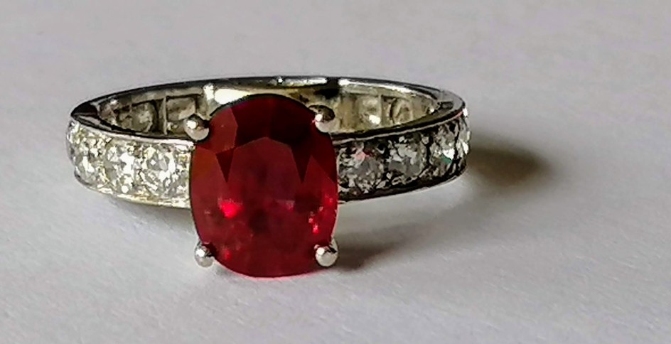 A fine oval Burmese ruby and diamond ring, 9.52 x 7.66 x 4.6...