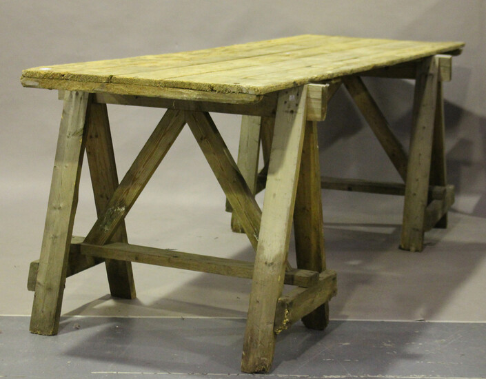 A large early/mid-20th century pine trestle table, the five-plank top on a pair of 'A' fra