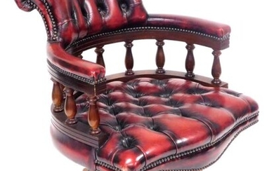 A mahogany and red leather captain's chair, with button...
