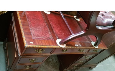 A mahogany pedestal desk with tooled red leather writing sur...