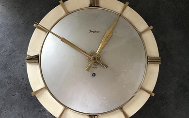 NOT SOLD. A metal wall clock with manual winding, hour markers and hands of brass. 1960s. Manufactured by Junghans. 1960s. – Bruun Rasmussen Auctioneers of Fine Art
